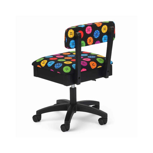 Arrow Bright Buttons Hydraulic Sewing Chair – rear angle view showing multicolor button print fabric, sturdy construction, and smooth-rolling caster wheels.
