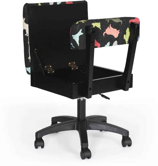 Arrow Dog’s Meow Hydraulic Sewing Chair Black – open seat storage compartment shown with sewing supplies, featuring colorful dog-print padded fabric.