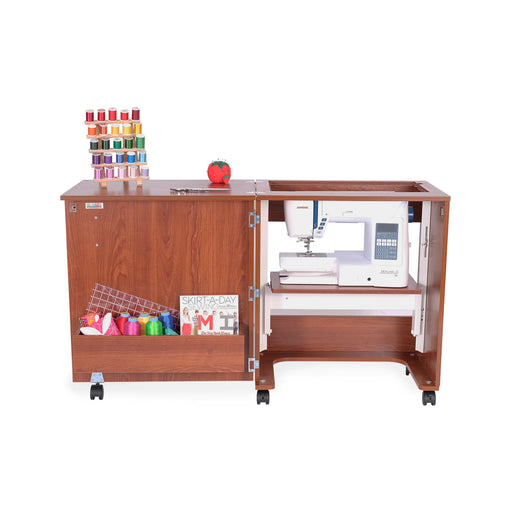 Arrow Judy 105 Teak Sewing Cabinet with hydraulic lift in flat-bed position holding sewing machine and organized sewing notions on top.