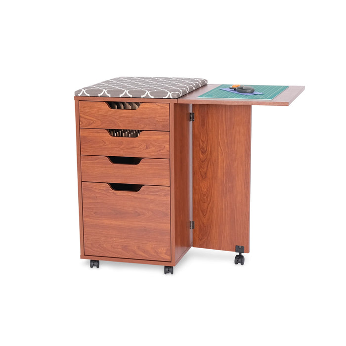 Kangaroo Kiwi Sewing Storage Cabinet in Teak K7105 shown with ironing board attached and cutting mat on extended side table.