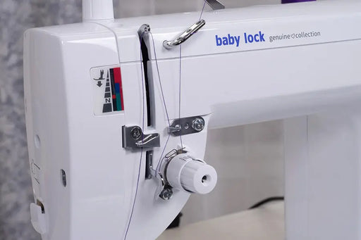Close-up of Baby Lock BL530B Accomplish 2 threading system and tension controls for precision straight-stitch sewing.