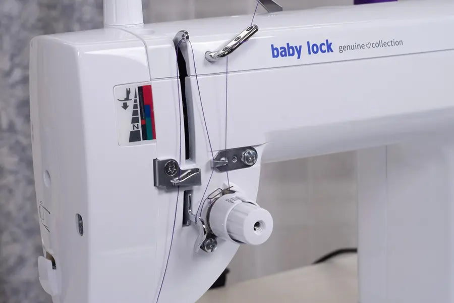 Close-up of Baby Lock BL530B Accomplish 2 threading system and tension controls for precision straight-stitch sewing.