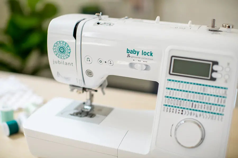 Baby Lock Jubilant BL80B Sewing Machine close-up on controls and stitching interface on a sewing table.
