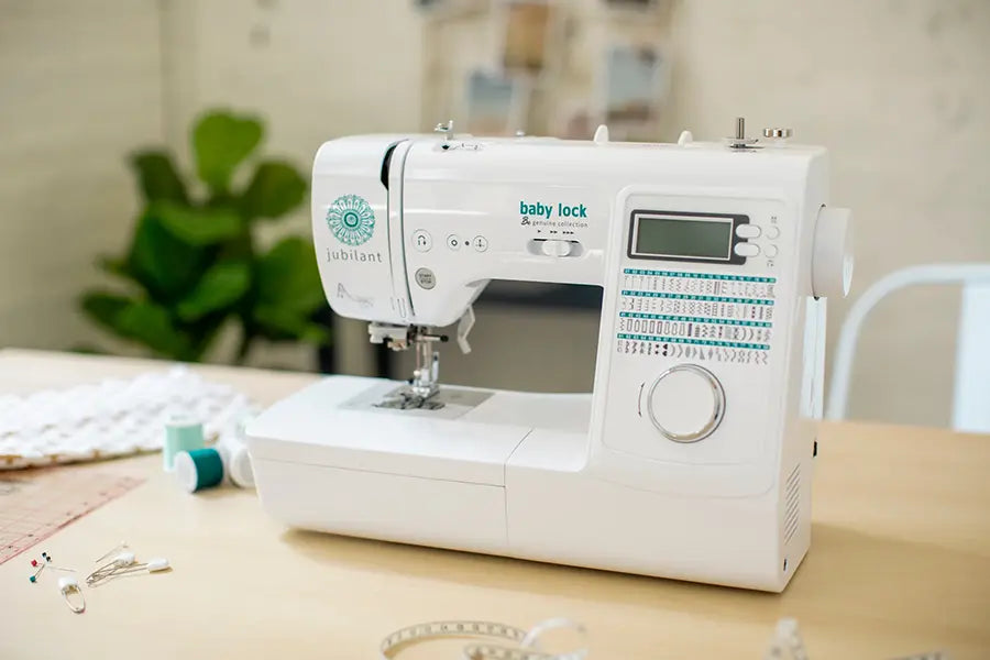 Baby Lock BL80B Jubilant Sewing Machine displayed in a creative workspace with sewing supplies.
