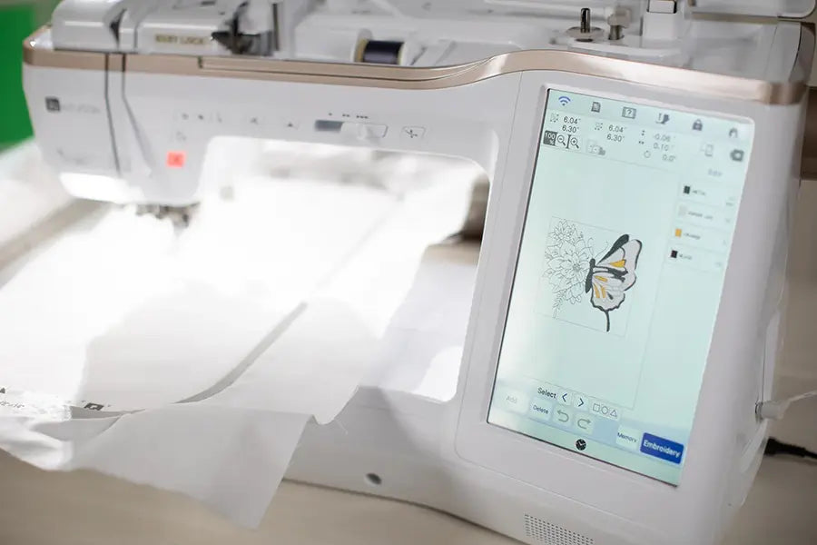Close-up of Baby Lock Altair 2 touchscreen showing a butterfly embroidery design being edited in IQ Designer.