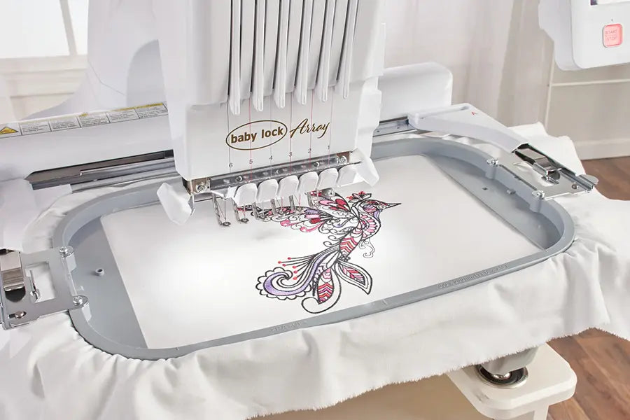 Close-up of Baby Lock Array embroidery machine stitching a detailed multicolor design in embroidery hoop