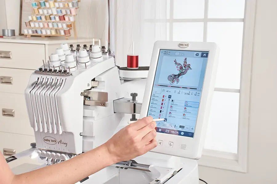 User operating the Baby Lock Array touchscreen to edit embroidery design on 6-needle embroidery machine