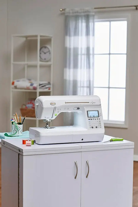 Baby Lock Lyric quilting and sewing machine displayed on a sewing cabinet in a bright craft room setting
