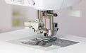 Close-up of Baby Lock Lyric sewing machine needle area, presser foot, and advanced needle threading system