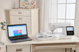 Baby Lock BLMVE Vesta connected to laptop for Wi-Fi embroidery design transfer in sewing workspace