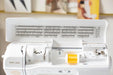 Baby Lock Brilliant sewing machine upper lid open showing built-in stitch library and threading path