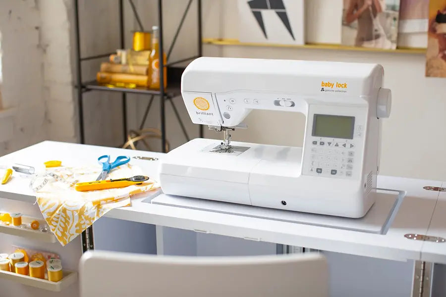 Baby Lock BL220B Brilliant Computerized Sewing Machine set up in a sewing studio workspace