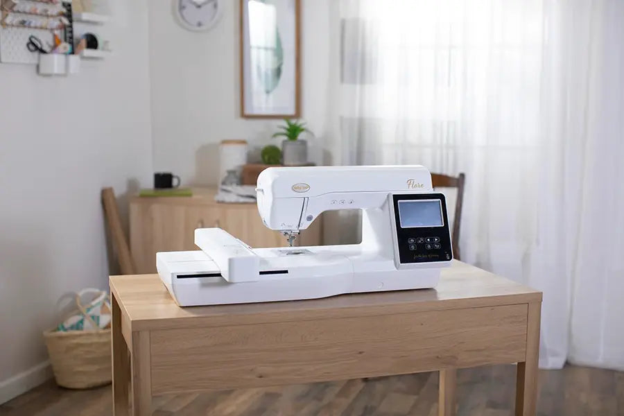 Baby Lock Flare BLMFL embroidery machine displayed in a sewing studio setting with extended embroidery arm.