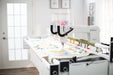 Baby Lock Gallant XL longarm quilting machine stitching a colorful quilt on the Villa 2 frame in a bright sewing studio