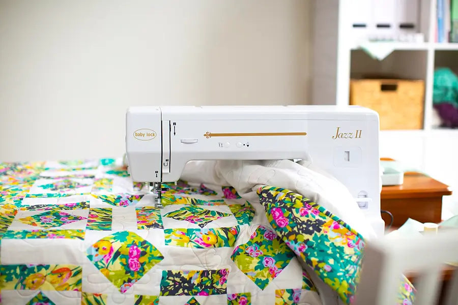 Baby Lock Jazz II BLMJZ-2D sewing machine displayed on a craft room table in a modern sewing workspace.