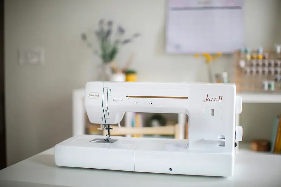 Baby Lock Jazz II BLMJZ-2D sewing and quilting machine displayed in a modern home sewing studio with extended 12-inch workspace.