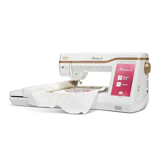 Side view of Baby Lock Meridian 2 embroidery machine actively stitching with extended embroidery arm, featuring advanced wireless design transfer and large workspace.