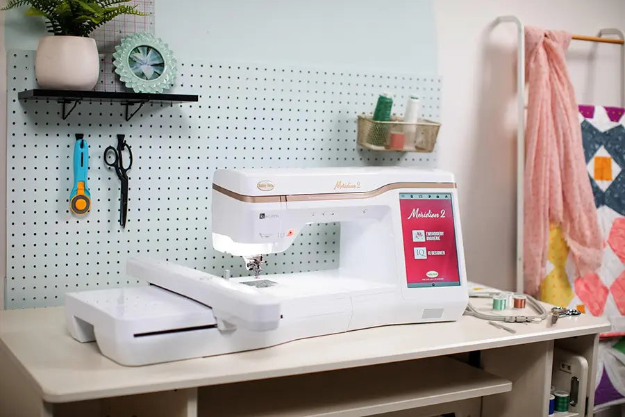 Baby Lock Meridian 2 embroidery machine positioned in a craft room with quilting tools, showing embroidery extension and intuitive design interface.