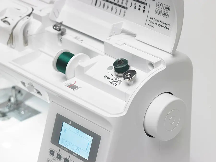 Close-up of Baby Lock Presto II bobbin winding area and upper threading system