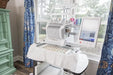 Baby Lock Venture 2 embroidery machine set up in a sewing studio, stitching multiple designs with touchscreen controls.