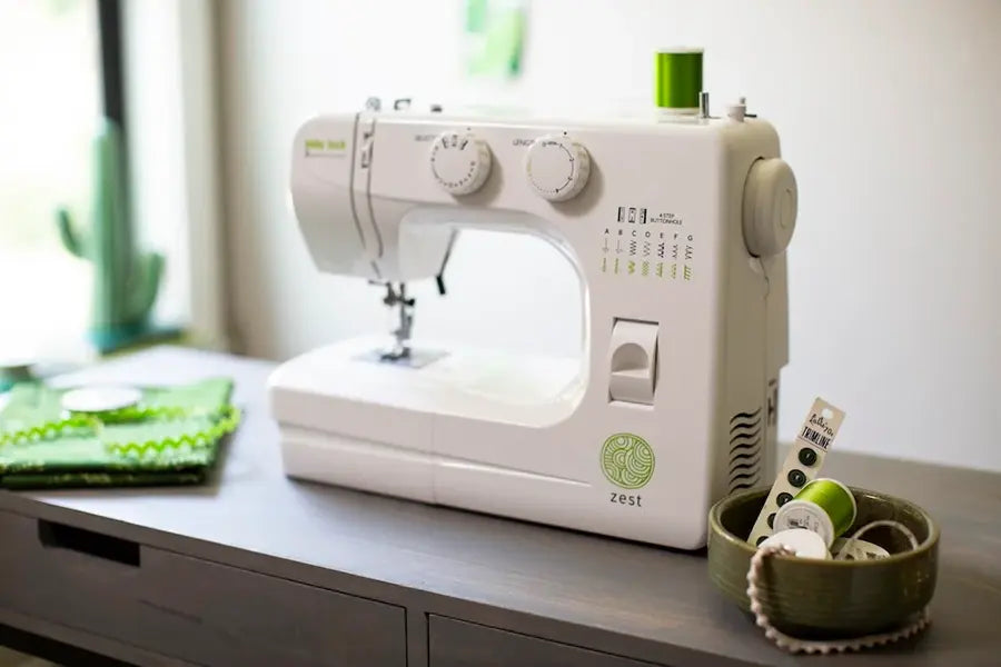 Baby Lock Zest BL15B mechanical sewing machine centered on modern sewing desk in home crafting space.