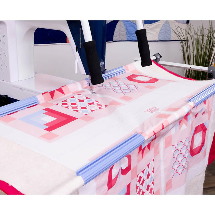 Grace Cutie Breeze tabletop quilting frame quilting a patterned quilt with adjustable front handles