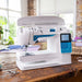 Husqvarna Viking Opal 650 sewing machine with top cover open showing bobbin winding system and internal threading path