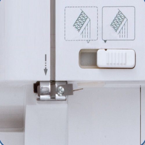 Close-up of Janome 1000CPX Seam Tightening System (STS) adjustment slider for precision coverstitch tension control.