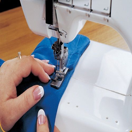 Janome CoverPro 1000CPX sewing a knit fabric hem, demonstrating smooth and accurate coverstitch performance.