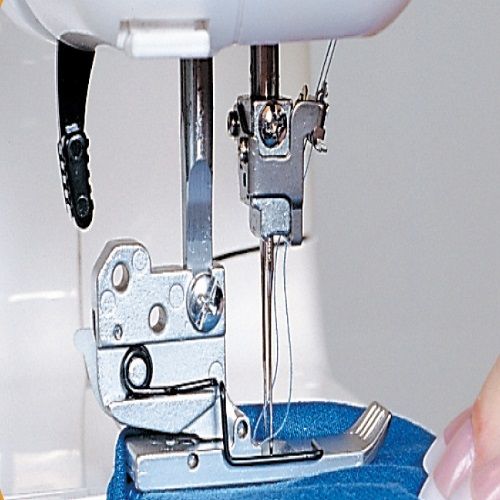 Detailed view of the Janome 1000CPX twin needle area and looper mechanism for high-quality coverstitch results.