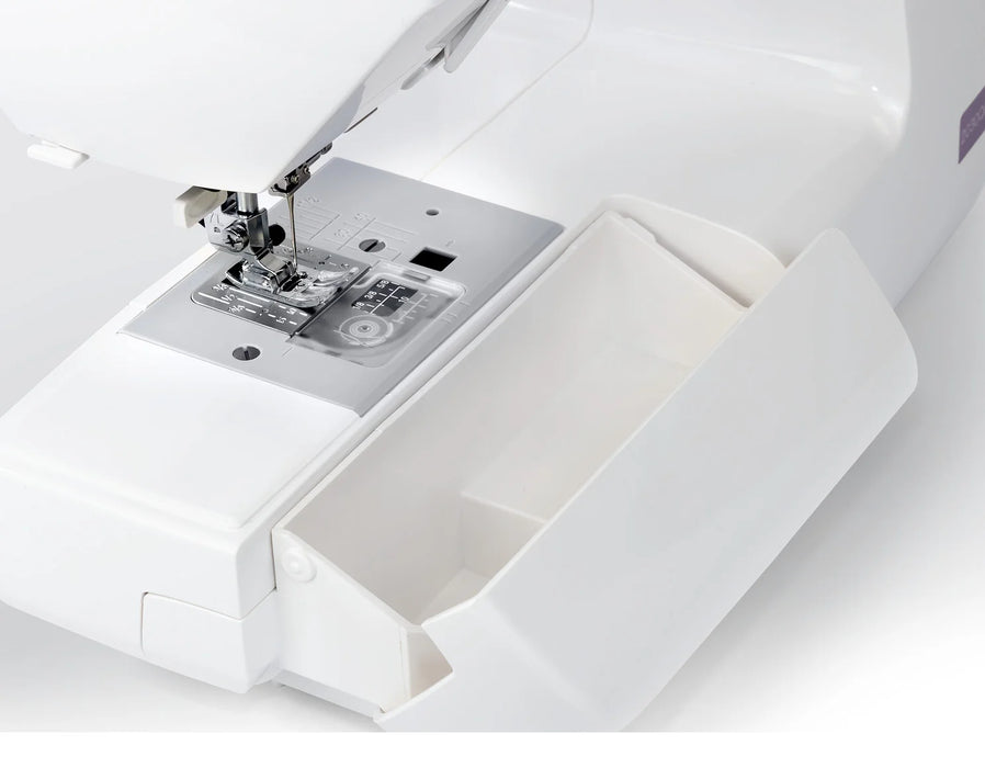 Removable storage compartment on the Janome 2030DC-G sewing machine designed to hold accessories and tools.