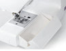 Removable storage compartment on the Janome 2030DC-G sewing machine designed to hold accessories and tools.