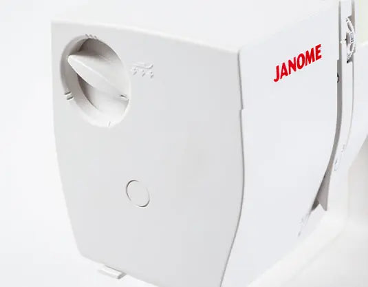Close-up of Janome Sewist 725S sewing machine side tension dial and upper threading area.