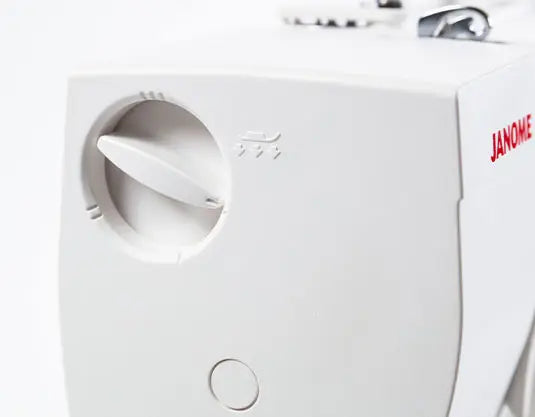 Detailed side view of the Janome Sewist 725S showing tension adjustment knob and Janome branding.