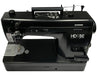 Top view of Janome HD9V2BE Professional Sewing Machine in black, highlighting controls and stitch plate area