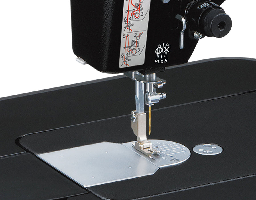 Close-up of Janome HD9V2BE needle area and presser foot, showing precision engineering for heavy fabrics