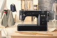 Janome HD9V2BE Professional Sewing Machine displayed in a tailor’s workshop environment