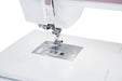 Close-up of the Janome 9410QC needle plate, presser foot, and feed dog system for high-accuracy sewing and quilting.