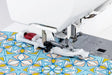 Janome Memory Craft 1000 sewing machine using buttonhole foot to stitch decorative fabric with precision