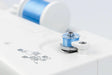 Close-up of Janome MC1000 bobbin winding system with blue thread for sewing and embroidery projects