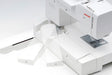 Janome Memory Craft 1000 embroidery unit showing folding arm mechanism for hoop attachment and setup