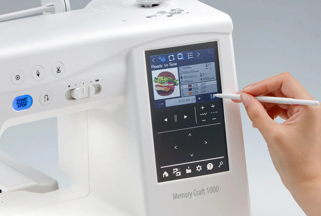Close-up of Janome MC1000 touchscreen showing embroidery design selection with stylus in use