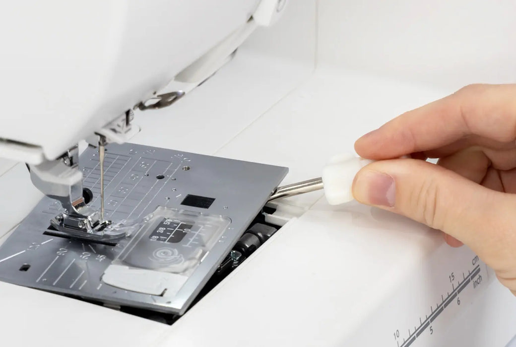 Removing the stitch plate on the Janome Memory Craft 1000 for cleaning and maintenance