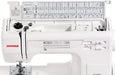 Janome HD-3000 sewing machine with top tray open, displaying built-in sewing guide, stitch options, and accessory storage.