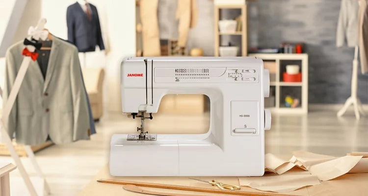 Janome HD-3000 Mechanical Sewing Machine displayed in a professional sewing studio setting, ideal for beginners and advanced sewists.
