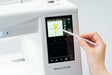 Close-up of Janome Memory Craft 100E LCD touchscreen showing embroidery design editing with stylus for precision control.