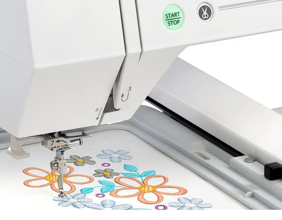 Close-up of Janome MC550E Limited Edition needle area stitching colorful floral embroidery design with precision.