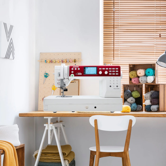 Janome MC6650 Memory Craft sewing machine displayed in modern craft room setting with yarn and sewing supplies
