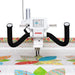 Janome Quilt Maker 18 long arm quilting machine close-up showing LCD touchscreen controls, ergonomic front handlebars, and precision stitching on a colorful quilt