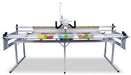 Janome Quilt Maker 18 long arm quilting machine mounted on 8 foot ProFrame, full front view with quilt loaded and professional stitch regulation system